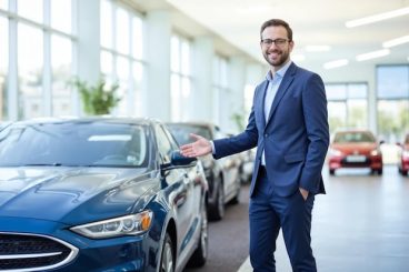 car-salesman-welcoming-customers-dealership_1410957-1069835